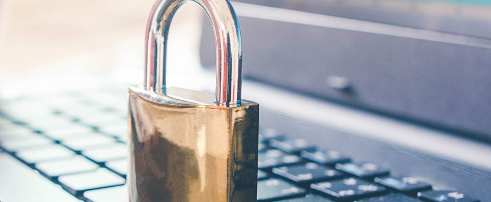 a brass padlock on laptop keyboard